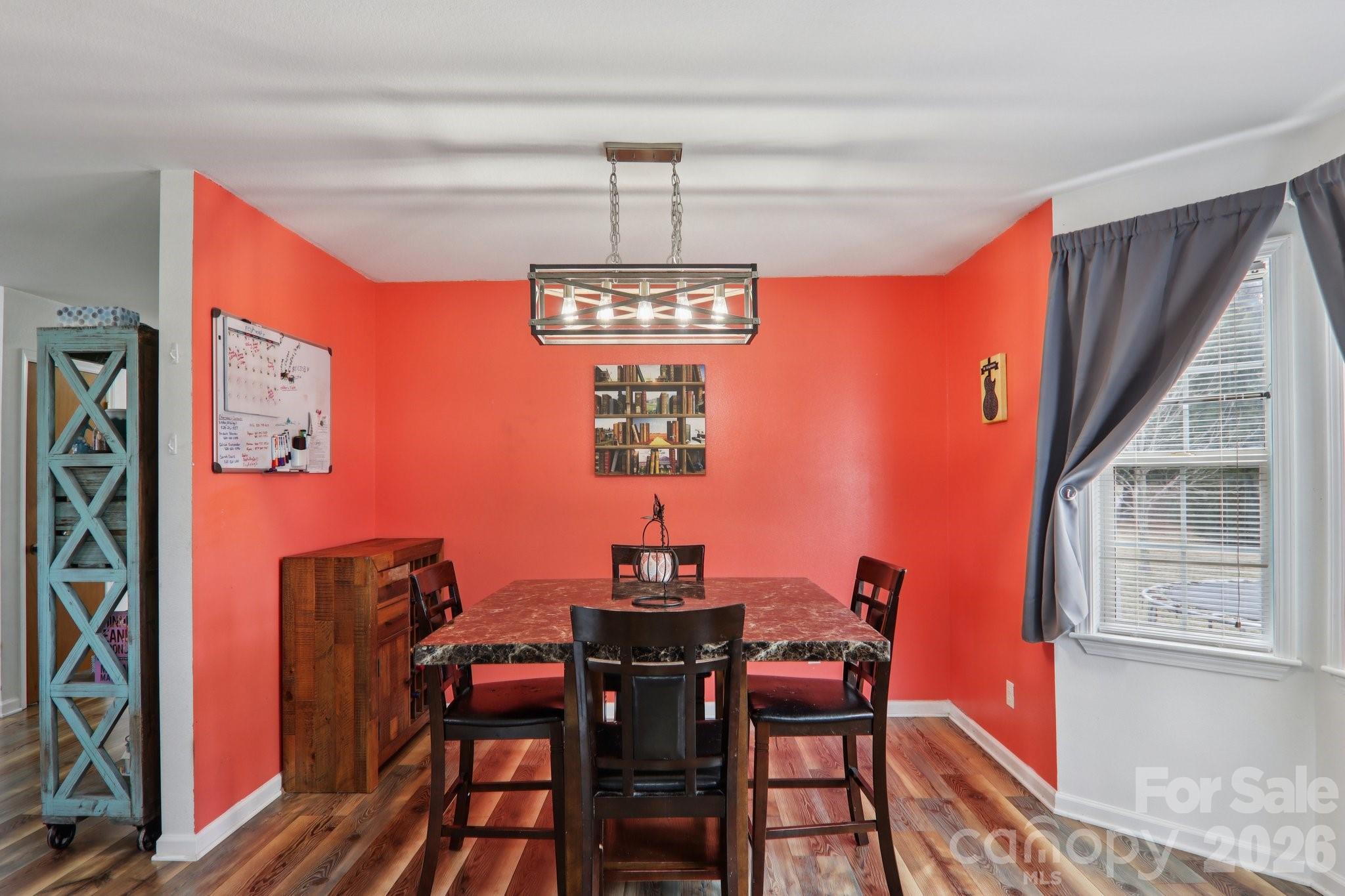 130 Crestview Street Canton, NC 28716 - Photo 15 of 42 a dining room with furniture a chandelier and wooden floor