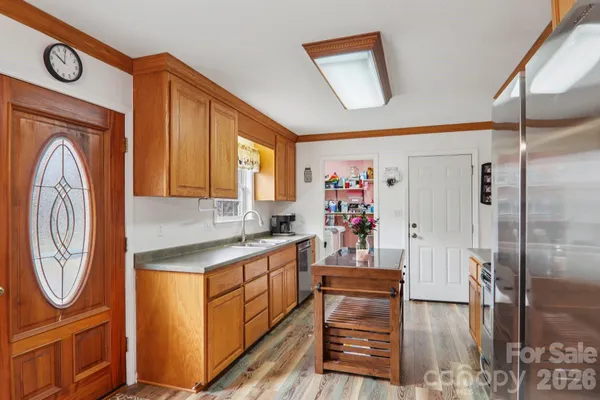 a kitchen with a refrigerator and a stove top oven