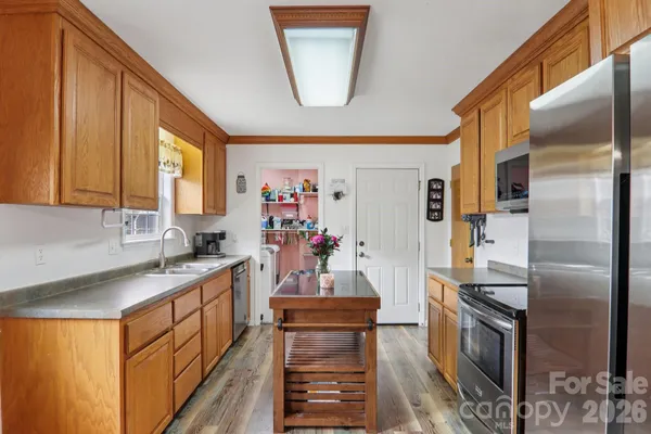 a kitchen with a sink appliances and cabinets