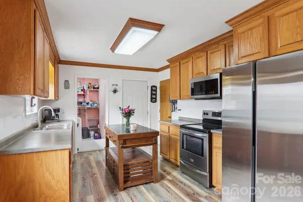 a kitchen with granite countertop a stove a sink and a microwave