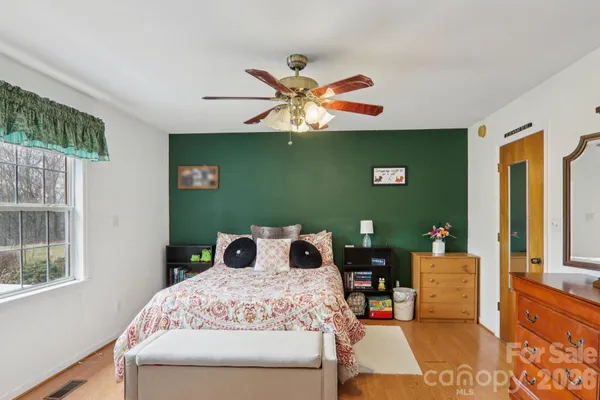 a bedroom with a bed and a chandelier
