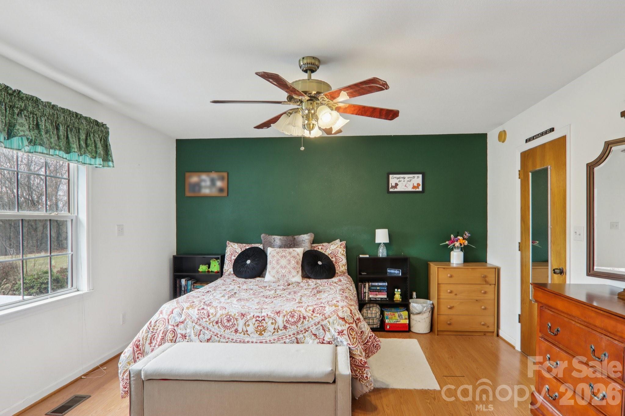 130 Crestview Street Canton, NC 28716 - Photo 24 of 42 a bedroom with a bed and a chandelier