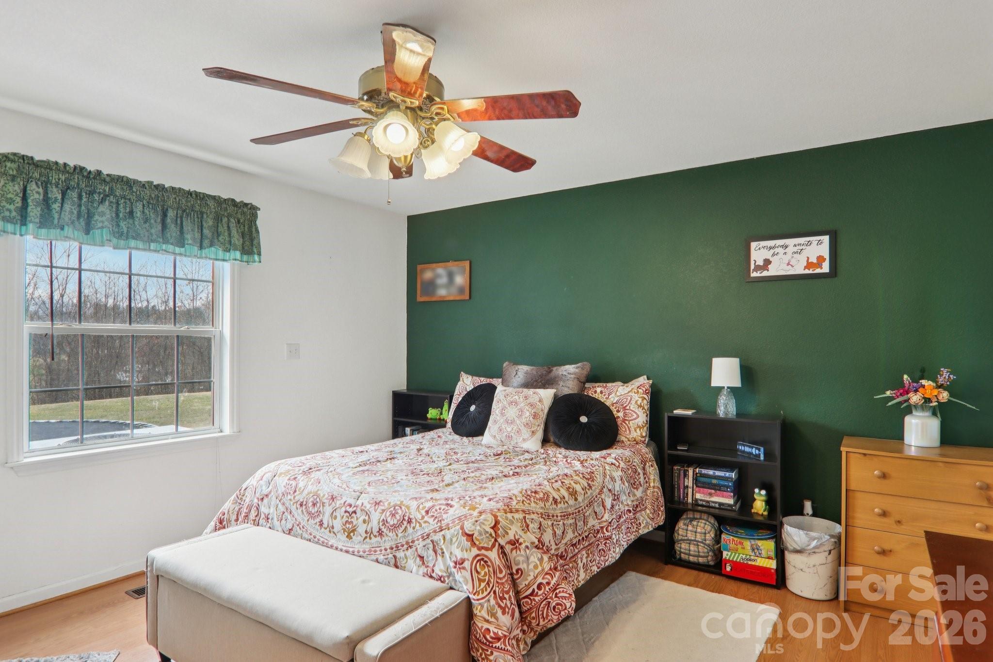130 Crestview Street Canton, NC 28716 - Photo 25 of 42 a bedroom with a bed and a chandelier