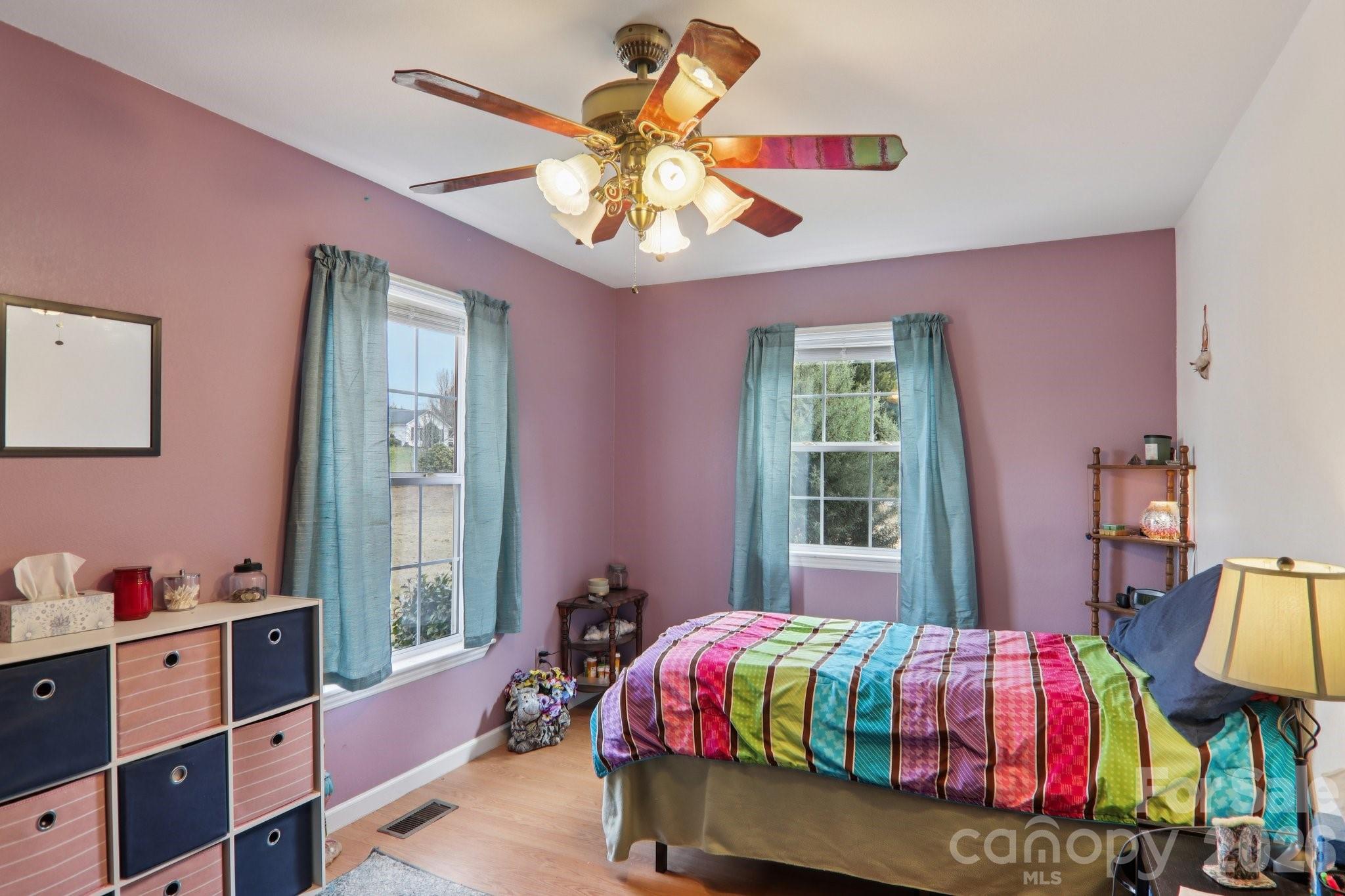 130 Crestview Street Canton, NC 28716 - Photo 29 of 42 a bedroom with a bed and wooden floor