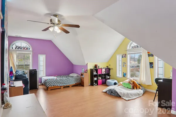 a bedroom with furniture and a large window