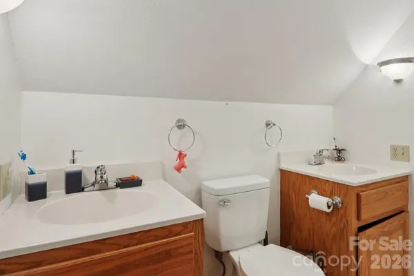 a bathroom with a sink vanity granite and toilet