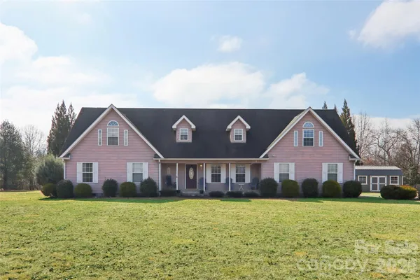 a front view of house with yard and seating space