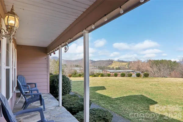a view of a patio with a table chairs and garden