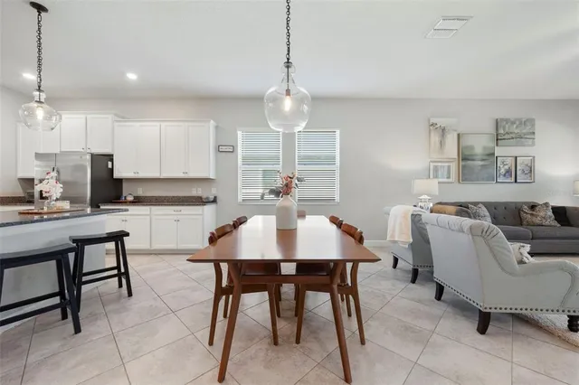a spacious bedroom with a bed a desk and chair