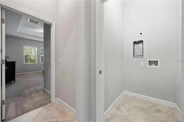 an aerial view of a house with yard swimming pool and mountain view in back