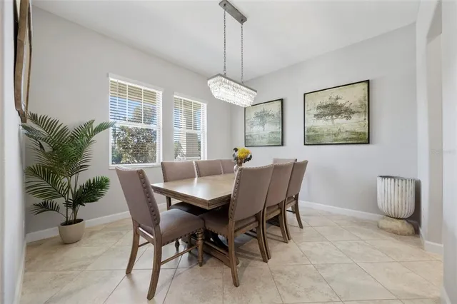 a spacious bedroom with a bed and a chandelier