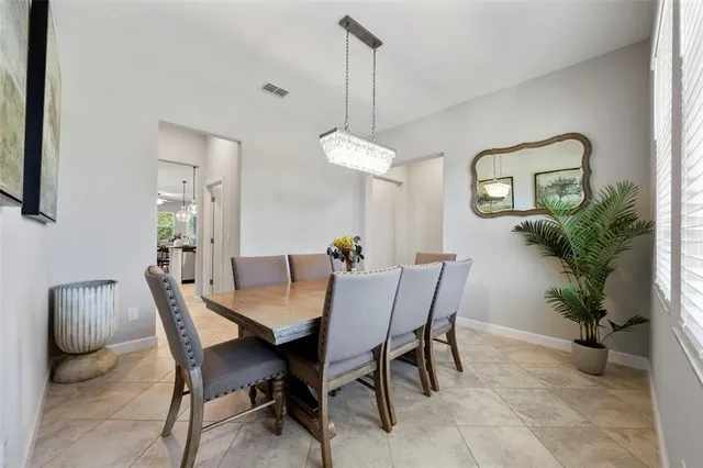 a spacious bedroom with a bed a couch and a large window