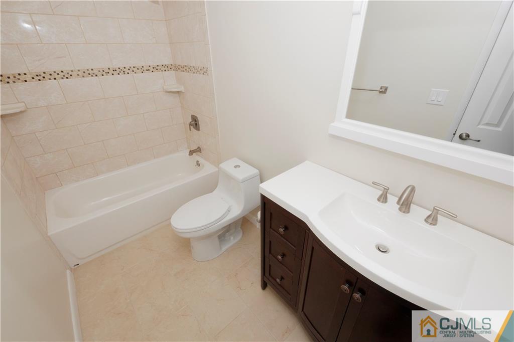 325 Middlewood Road Middletown, NJ 07748 - Photo 14 of 21 a bathroom with a sink a toilet and bathtub