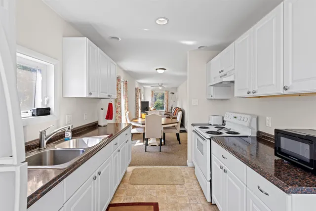 a view of a kitchen with sink and cabinets