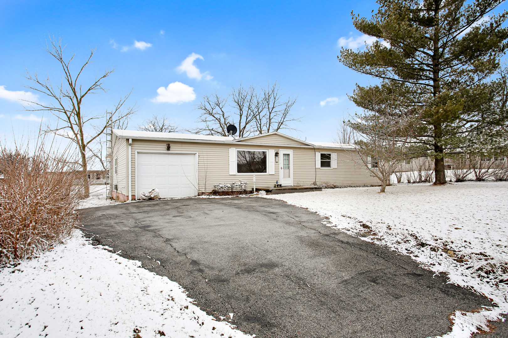 152 Iroquois Trail Loda, IL 60948 - Photo 1 of 33 a front view of a house with a yard covered in snow