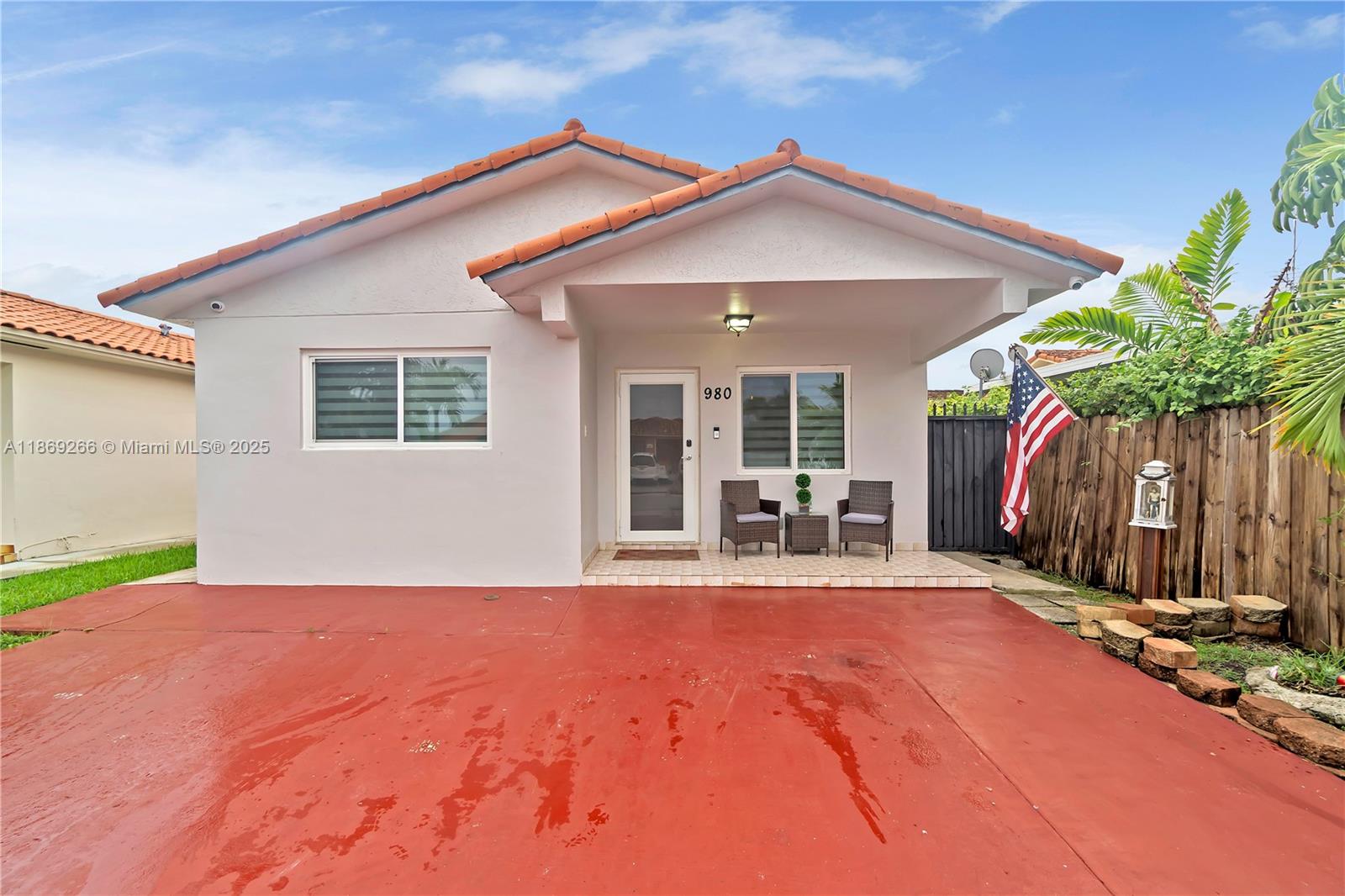 980 West 43rd Place, Unit 980 Hialeah, FL 33012 - Photo 1 of 17 a front view of a house with a yard and garage