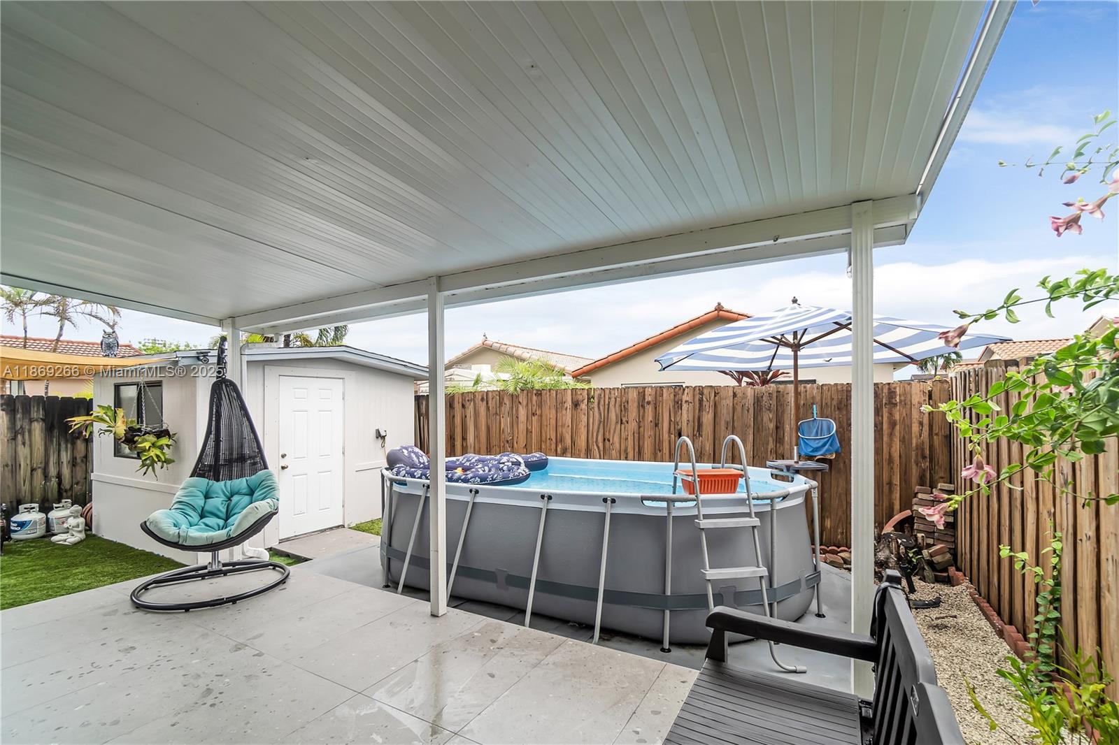 980 West 43rd Place, Unit 980 Hialeah, FL 33012 - Photo 13 of 17 a view of a garage with table and chairs