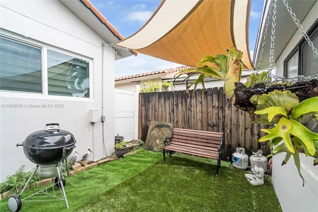 a backyard of a house with garden and plants