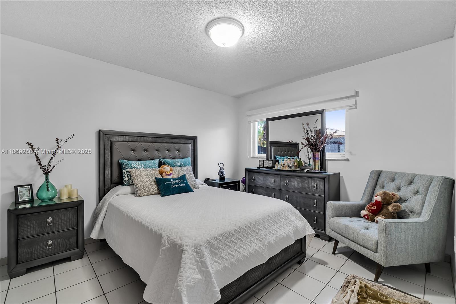 980 West 43rd Place, Unit 980 Hialeah, FL 33012 - Photo 8 of 17 a bedroom with a bed and a couch