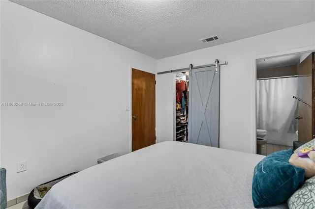 a bedroom with a bed and a closet