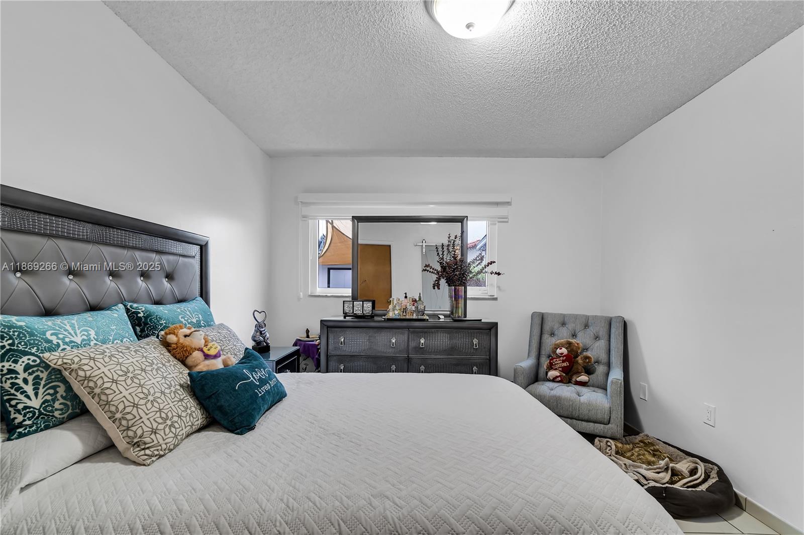 980 West 43rd Place, Unit 980 Hialeah, FL 33012 - Photo 10 of 17 a bedroom with a bed and wooden floor