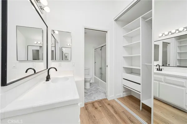 a bathroom with a sink a toilet and a mirror