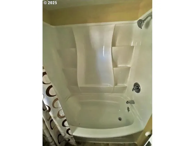 a bathroom with a shower and a glass door