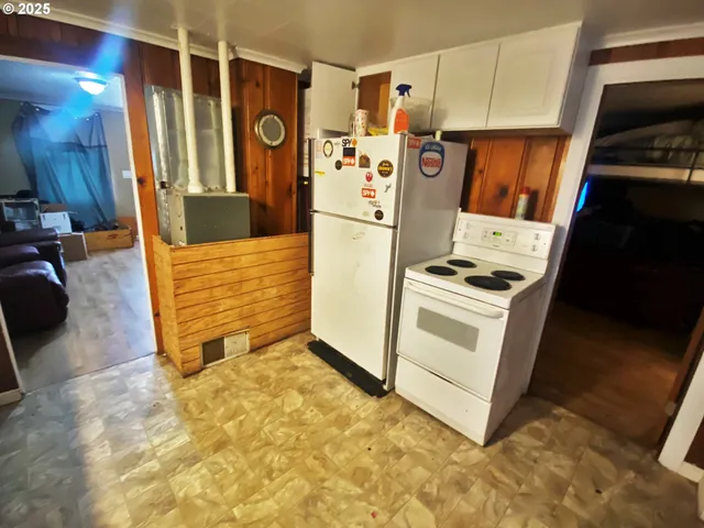 a view of appliances with storage and utility room