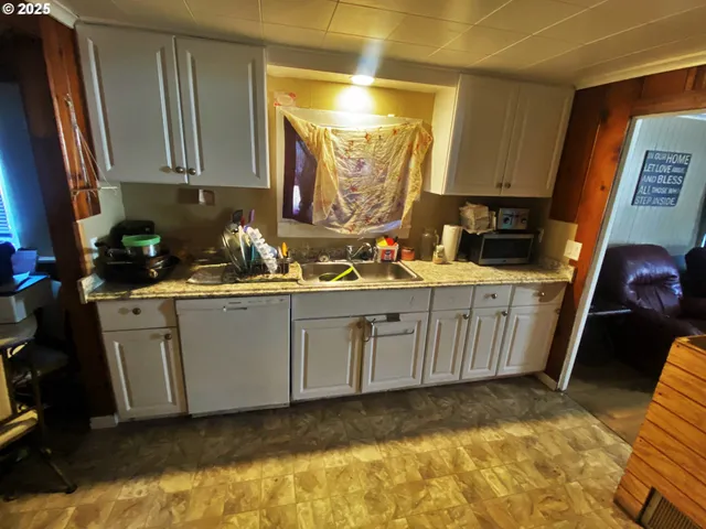 a kitchen with sink cabinets and window