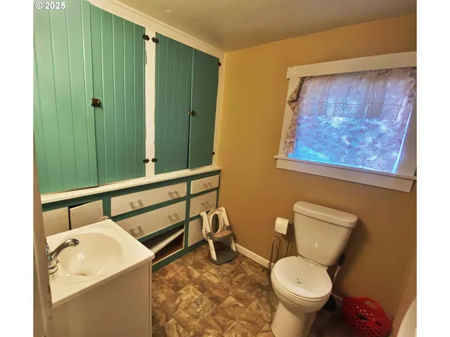 a bathroom with a toilet and a sink
