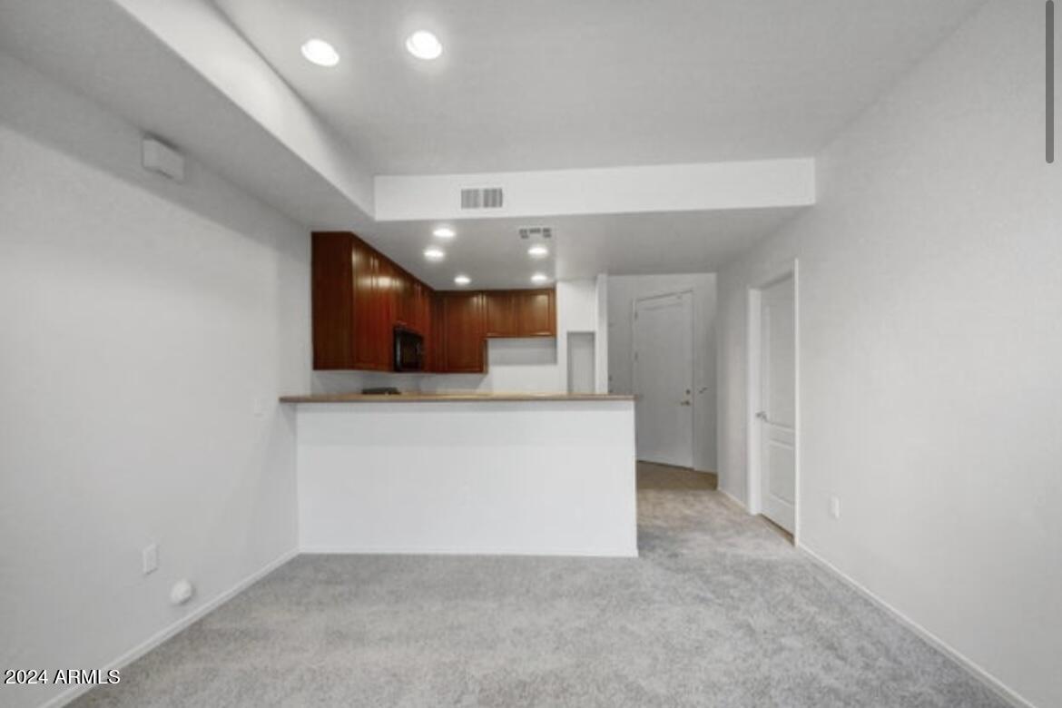 705 West Queen Creek Road, Unit 1207 Chandler, AZ 85248 - Photo 12 of 21 a view of a hallway to room with wooden floor