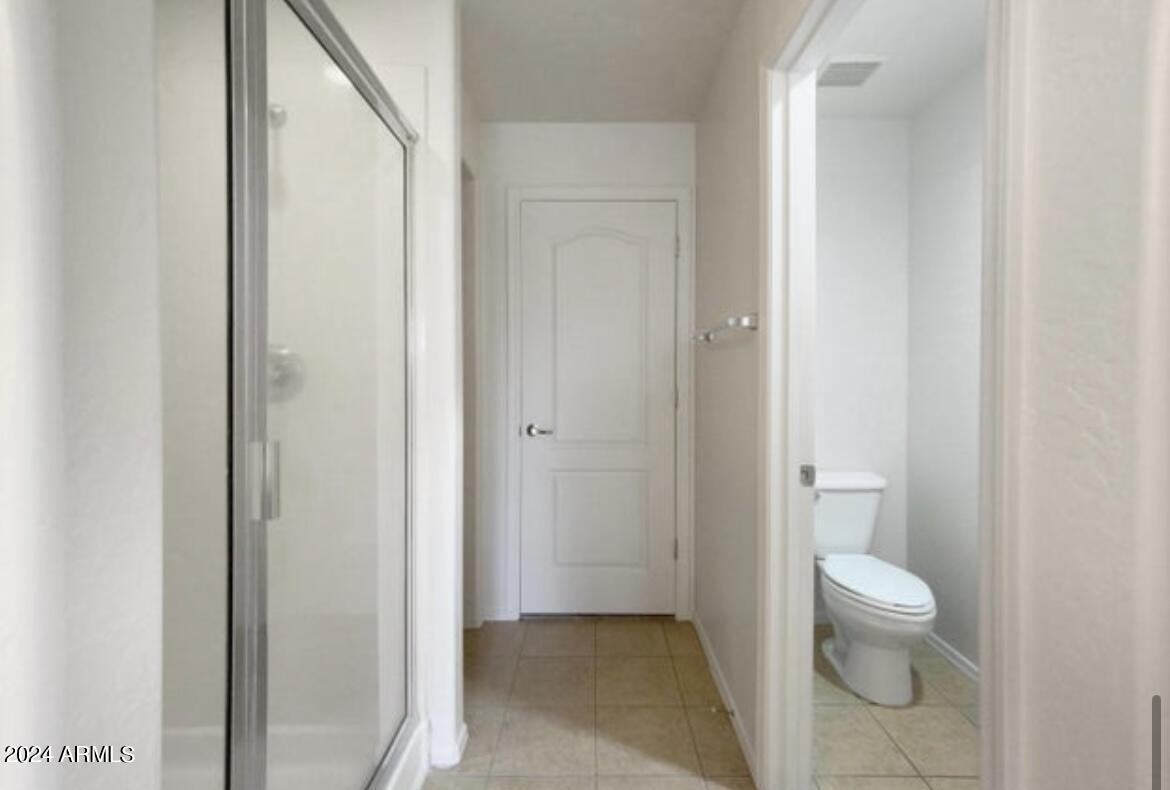 705 West Queen Creek Road, Unit 1207 Chandler, AZ 85248 - Photo 17 of 21 a bathroom with a granite countertop sink a toilet and a shower