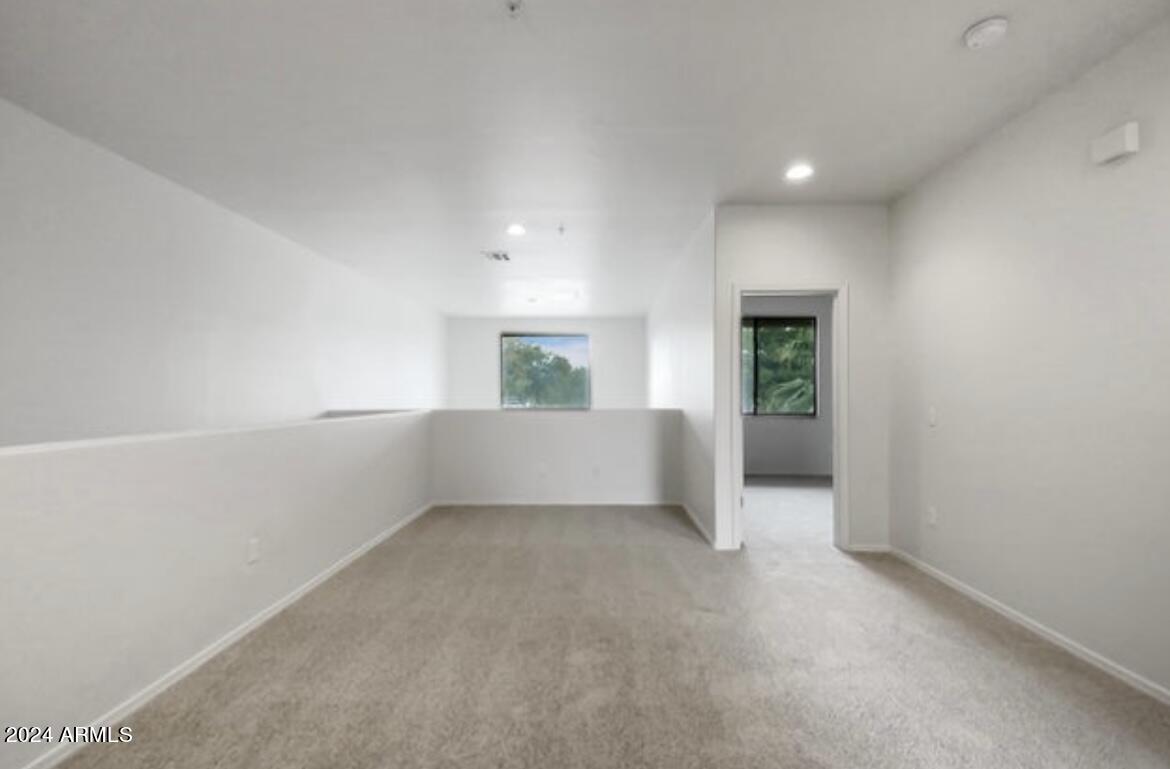705 West Queen Creek Road, Unit 1207 Chandler, AZ 85248 - Photo 18 of 21 an empty room with windows