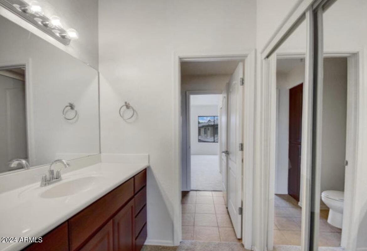 705 West Queen Creek Road, Unit 1207 Chandler, AZ 85248 - Photo 20 of 21 a bathroom with a double vanity sink and mirror
