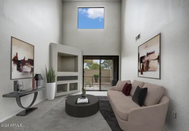 a living room with furniture and a potted plant