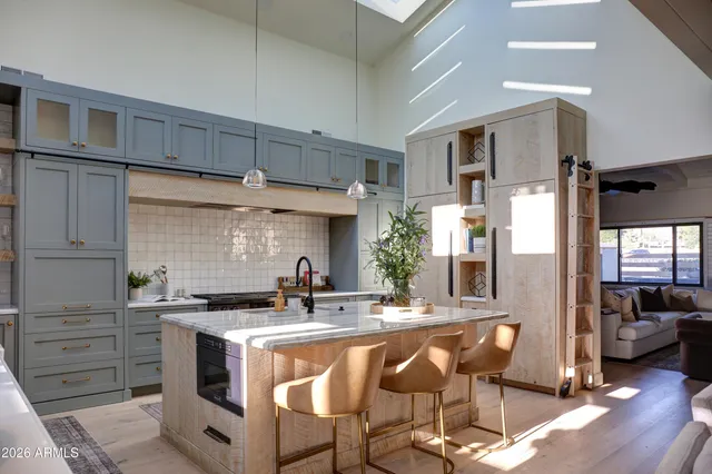 a kitchen with stainless steel appliances kitchen island granite countertop a sink and cabinets