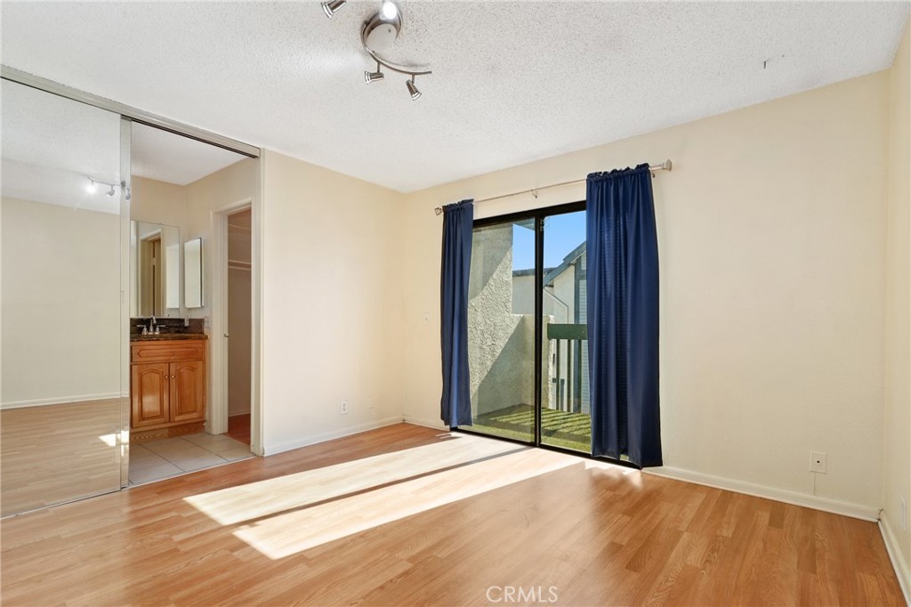 13522 Francisquito Avenue, Unit C Baldwin Park, CA 91706 - Photo 17 of 35 a bedroom with a bed and a view of bathroom