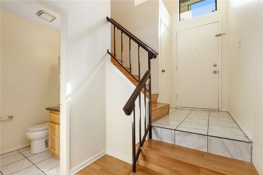 13522 Francisquito Avenue, Unit C Baldwin Park, CA 91706 - Photo 2 of 35 a view of a hallway with wooden floor and staircase