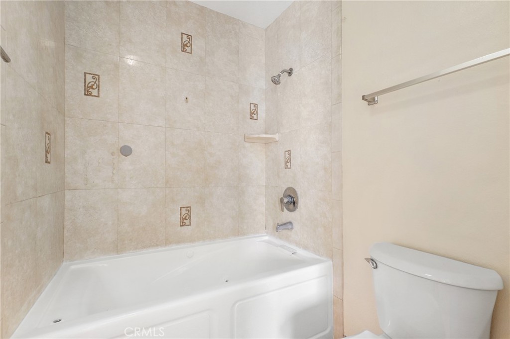 13522 Francisquito Avenue, Unit C Baldwin Park, CA 91706 - Photo 21 of 35 a bath room with a toilet and a bath tub