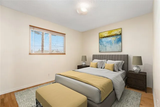 a bedroom with a bed and a wall painting