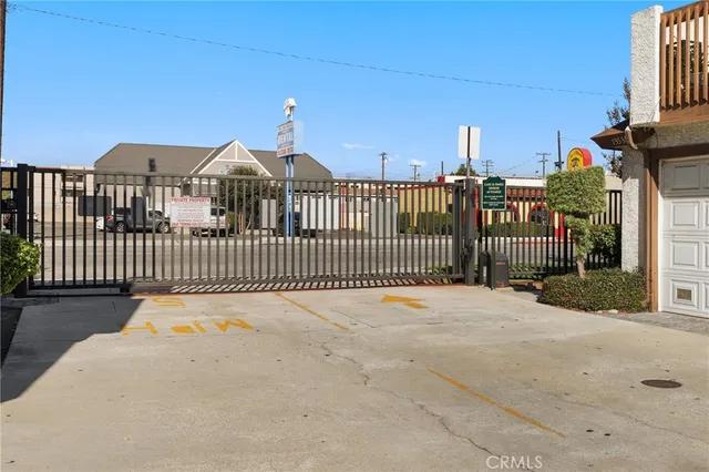 a view of a street with wooden fence