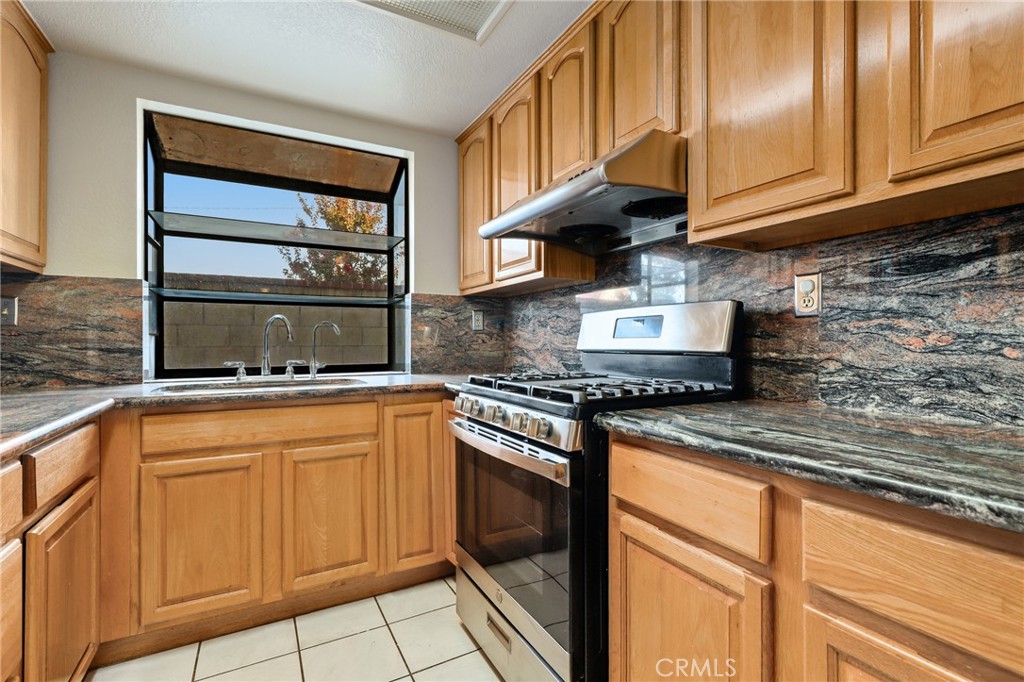 13522 Francisquito Avenue, Unit C Baldwin Park, CA 91706 - Photo 10 of 35 a kitchen with stainless steel appliances granite countertop a stove and a microwave
