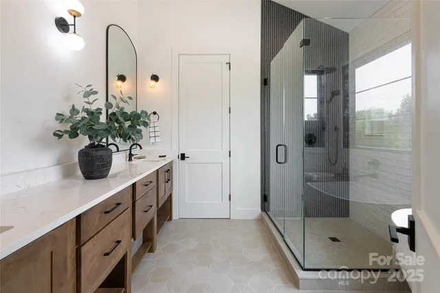 a bathroom with a shower sink and mirror