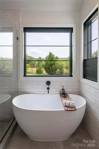 a bathroom with a bathtub and a window