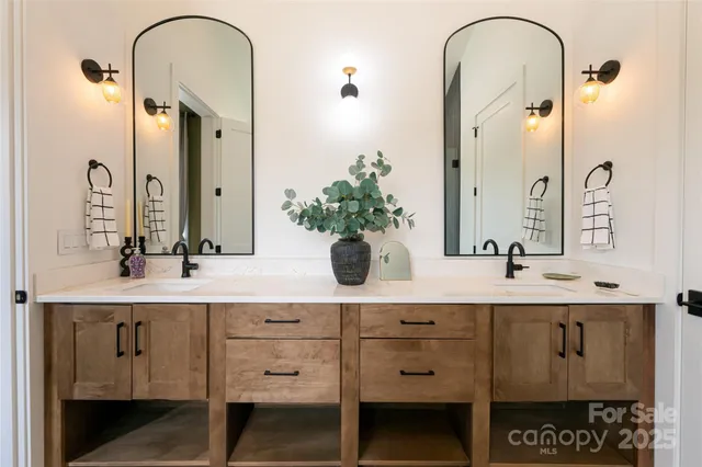 a bathroom with a double vanity sink and a mirror