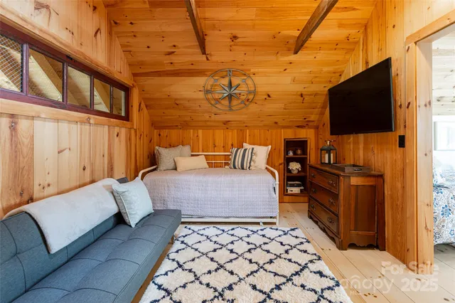 a bedroom with furniture and flat screen tv