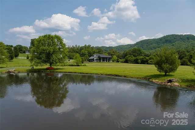 a view of a lake with a house in the background