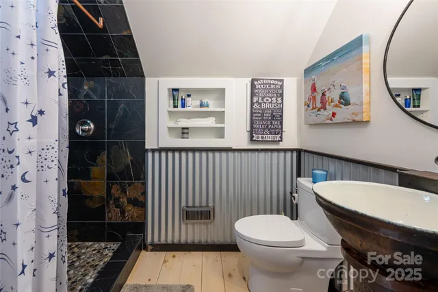 a white toilet sitting next to a bathroom sink
