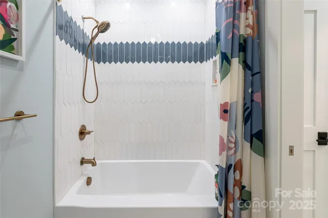 a bathroom with a bathtub and a shower