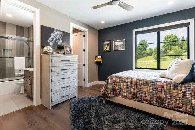 a bedroom with a bed and large window